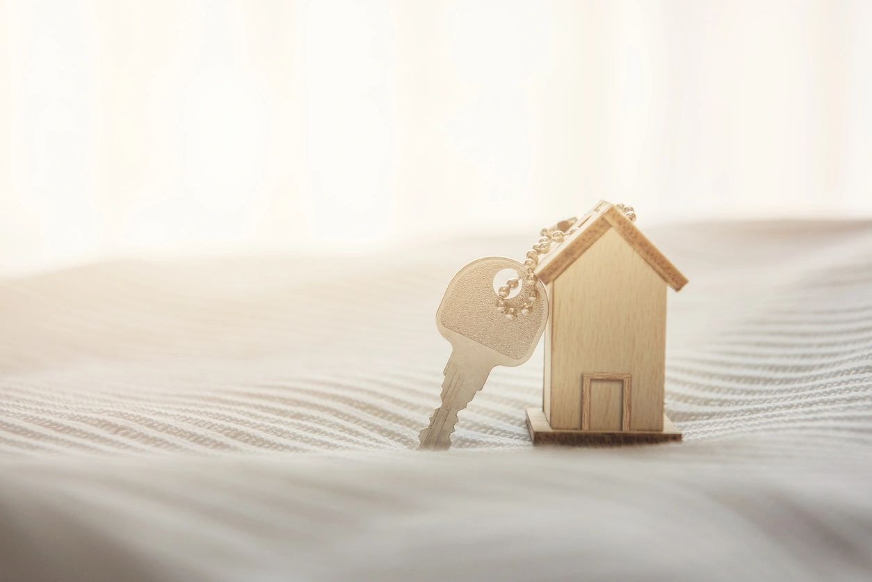 Wooden house model with gold key